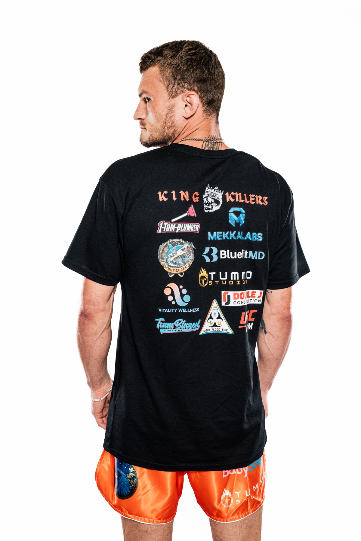 Mike Heckert showing sponsor logos on a King Killers shirt